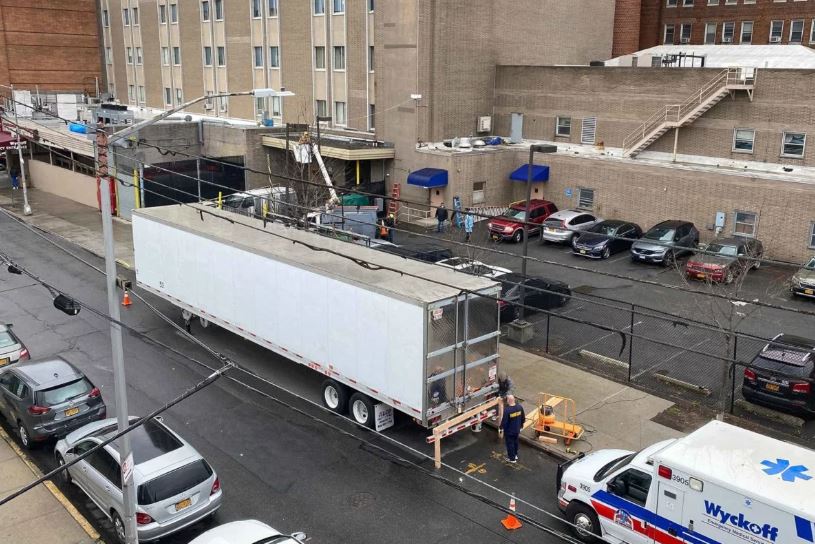 refrigerated truck is now parked outside to accommodate the overflow